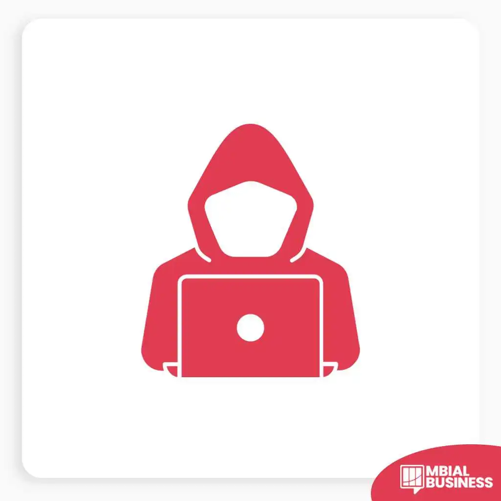 A red icon of a faceless person wearing a hoodie, sitting and looking at a laptop with a glowing white circle on the screen. The icon is on a white background with a subtle grey border and a red "MBIAL BUSINESS" logo in the bottom right corner.